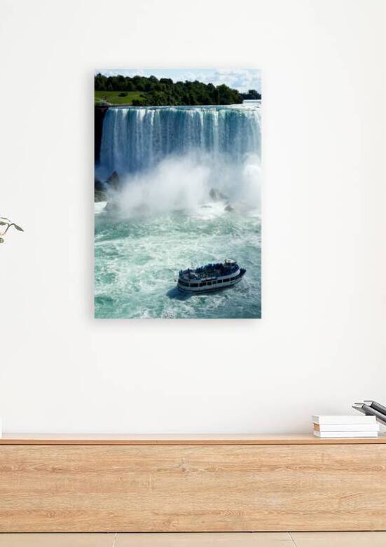 Maid of the Mist boat with tourists at Niagara Falls. by Marco Brivio