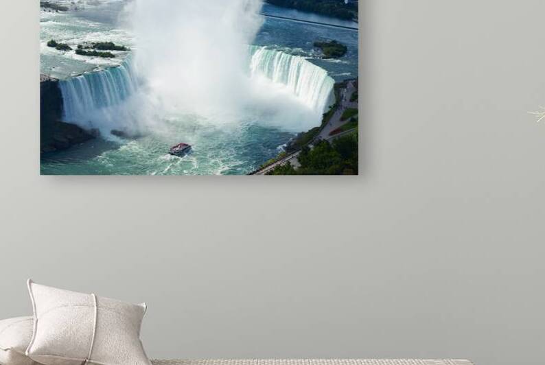 Majestic Niagara Falls a boat braves the mist. by Marco Brivio