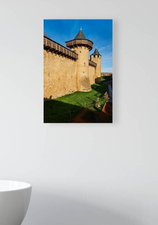 Tourists walk along the stone walls of Carcassonne by Marco Brivio