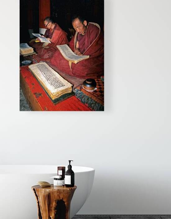 Monks read sacred texts in a Tibetan temple at night by Marco Brivio