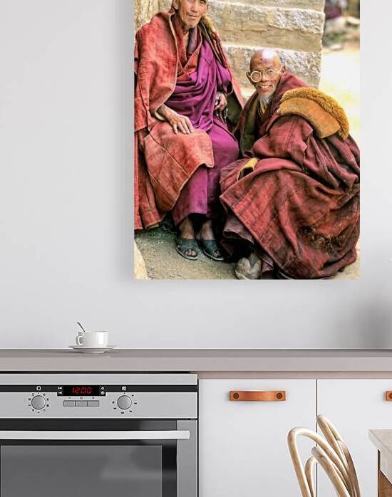 Two smiling elderly monks share a moment in Tibet by Marco Brivio