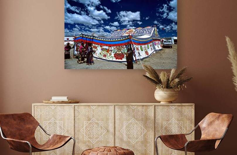 Colorful Tibetan tent with people under a cloudy sky in Tibet by Marco Brivio