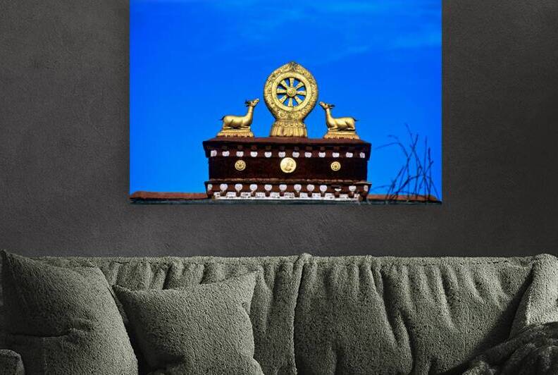 Golden Dharma wheel and deer statues on temple roof in Tibet by Marco Brivio