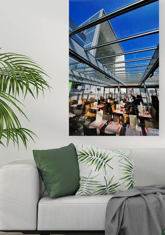 Dining area in Paris with modern building under clear sky by Marco Brivio