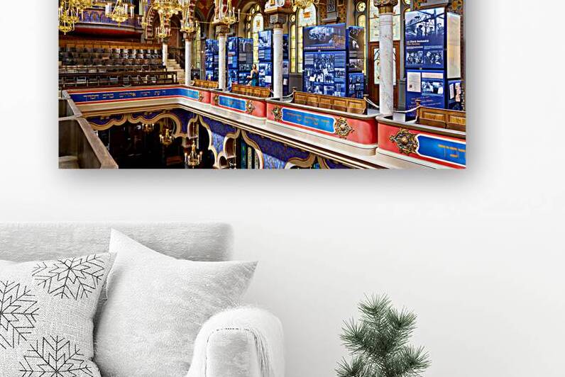 Ornate synagogue interior with historical exhibition displays. by Marco Brivio