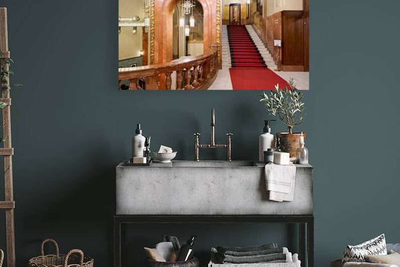 Elegant interior with red carpeted staircase and ornate gold det by Marco Brivio