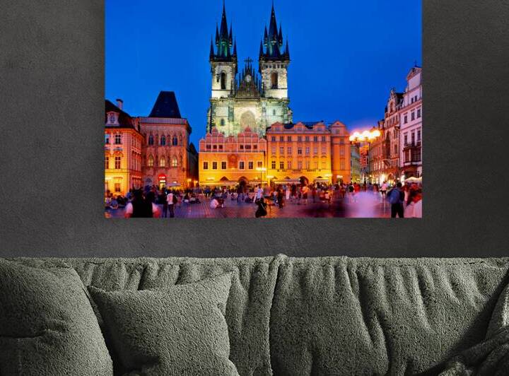 Pragues Old Town Square at night illuminated church and crowd. by Marco Brivio