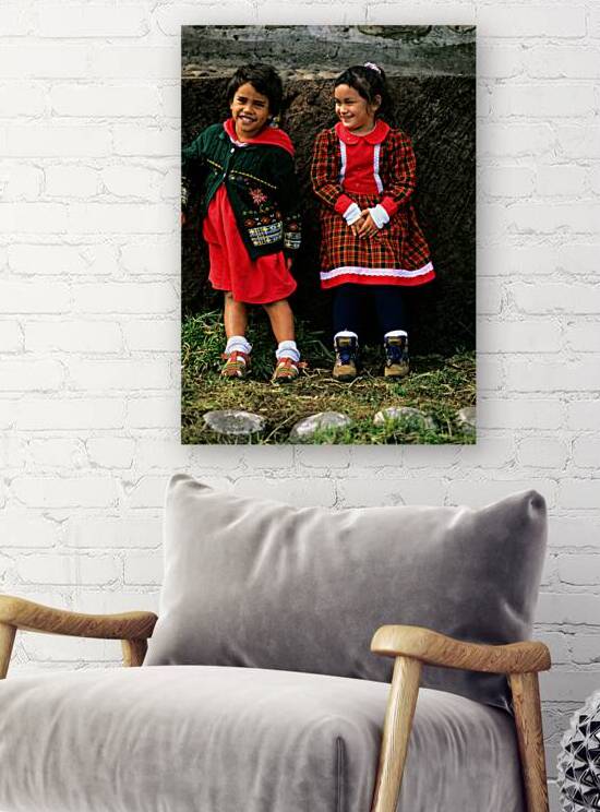 Two young girls smiling dressed in colorful outfits at Easter I by Marco Brivio