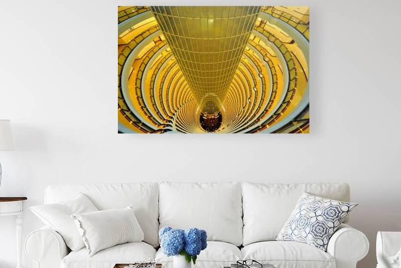 Golden hotel atrium with glass elevator in Shanghai China by Marco Brivio