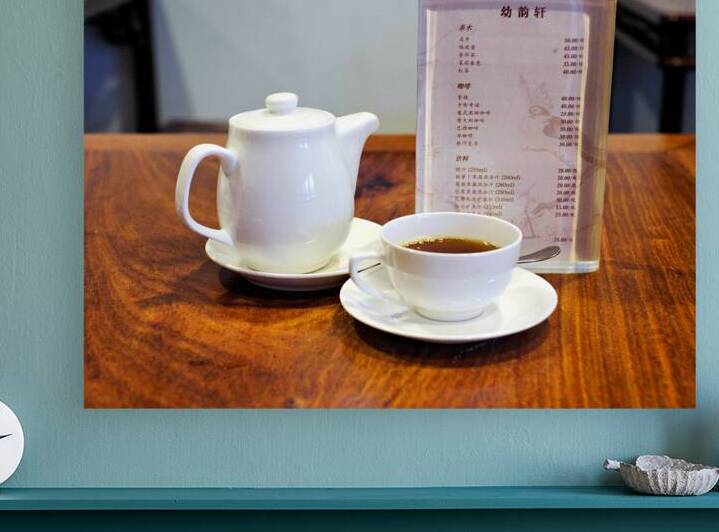 Enjoying tea and menu on a wooden table in Shanghai by Marco Brivio