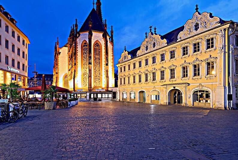 Wurzburg at dusk with Marienkapelle and Falcon House in view by Marco Brivio