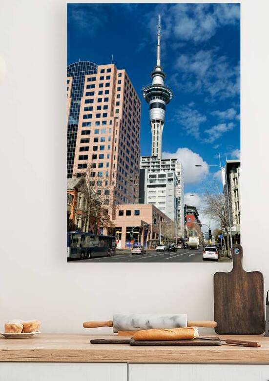 Sky Tower rises above Auckland city buildings in New Zealand by Marco Brivio