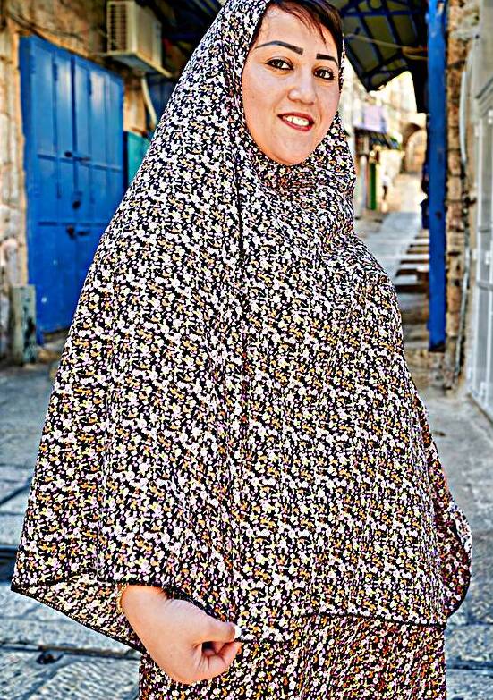 Portrait of a woman in Jerusalem Israel walking on a street by Marco Brivio