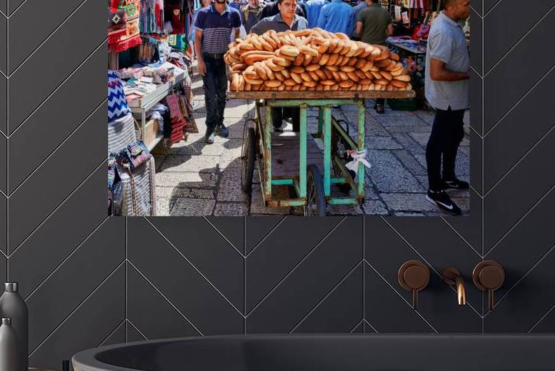 Carrying bread through the streets of old Jerusalem in Israel by Marco Brivio