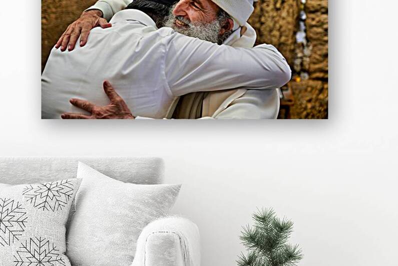 Men embrace each other at the Wailing Wall in Jerusalem by Marco Brivio