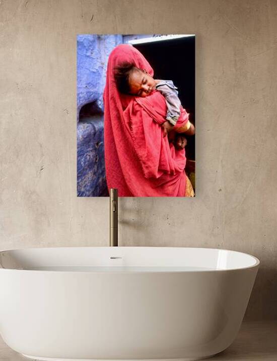 Mother carries sleeping child in India during daytime by Marco Brivio