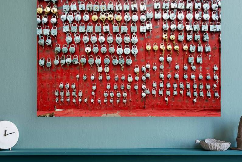 Lockers displayed on a red wall in Bundi market Rajasthan Indi by Marco Brivio