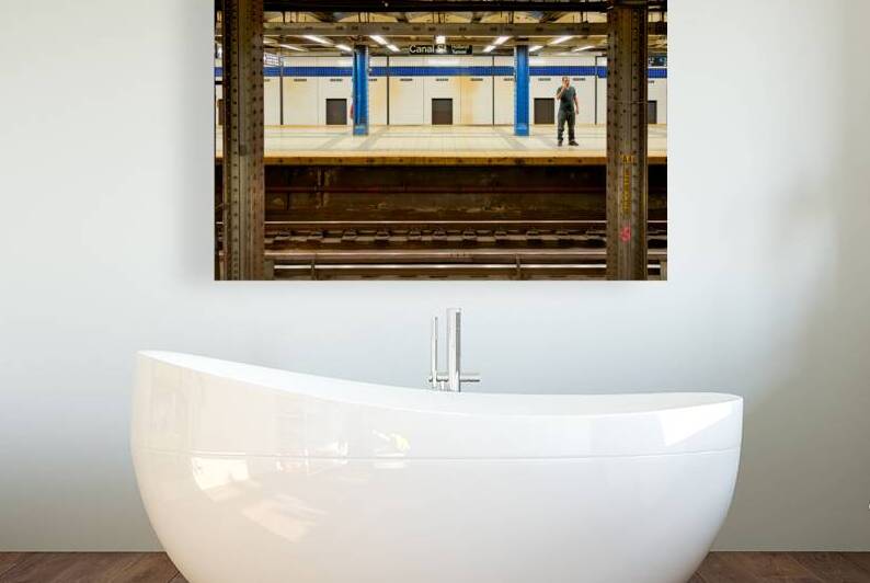 Man waits at Canal Street subway station in Manhattan by Marco Brivio