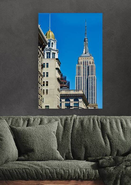 Empire State Building stands tall in Manhattan under clear blue  by Marco Brivio