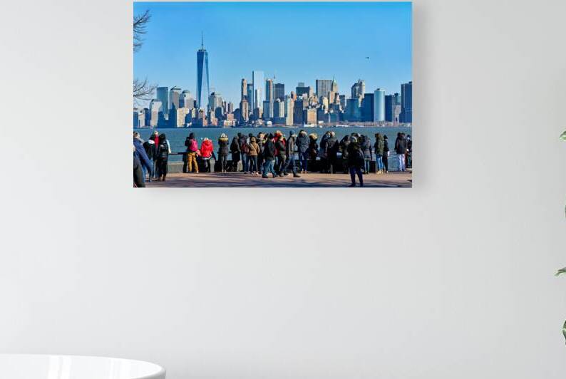 Tourists look at Manhattan skyline from Liberty Island in New Yo by Marco Brivio