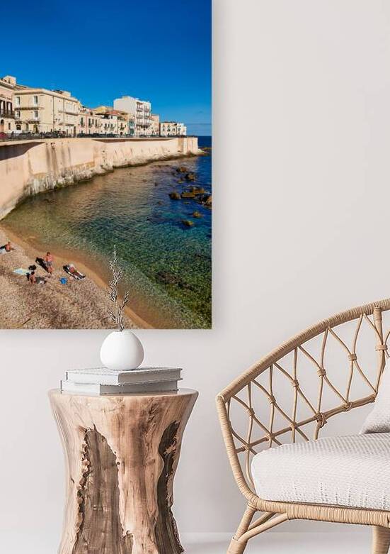 Visitors relax by the seashore in Syracuse Ortigia Sicily Ital by Marco Brivio