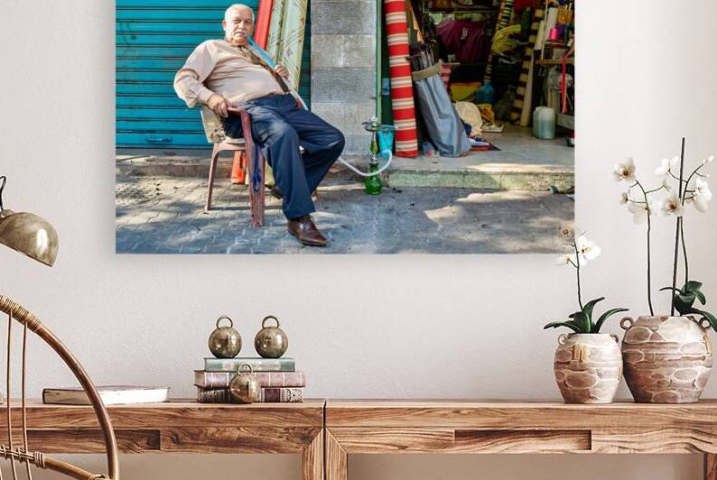 Senior citizen smokes shisha by shop in Amman Jordan by Marco Brivio
