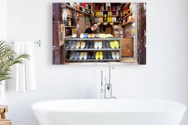 Moroccan babouches shoes in a Fez shop with a vendor by Marco Brivio