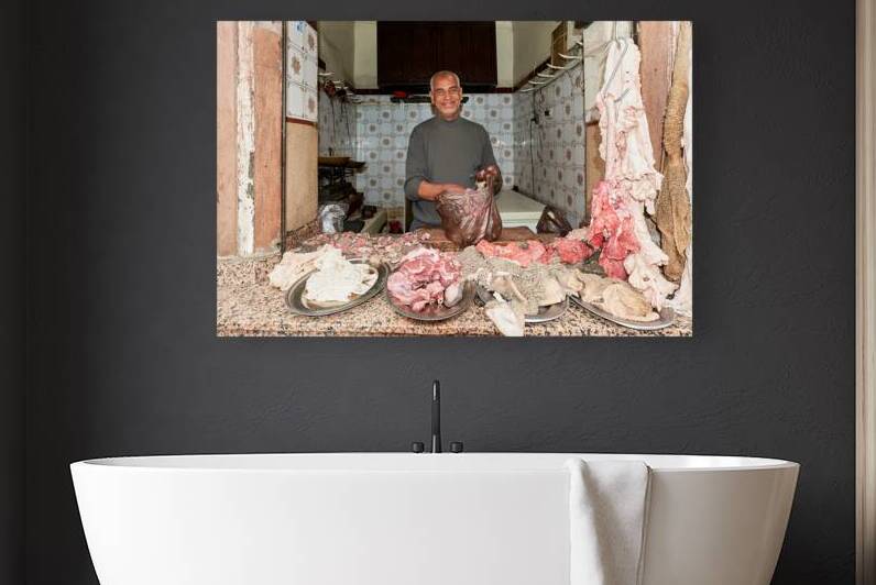 Butcher working in the Medina of Marrakesh Morocco with fresh  by Marco Brivio