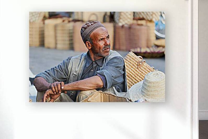 Portrait of a man in Marrakesh market selling handmade goods by Marco Brivio