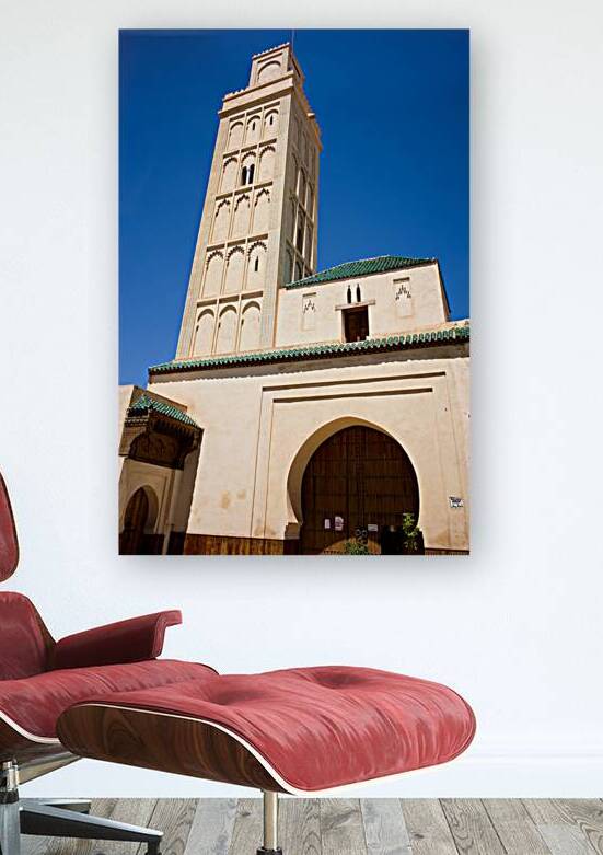 Visit Meknes mosque in Morocco with a tall tower and clear sky by Marco Brivio