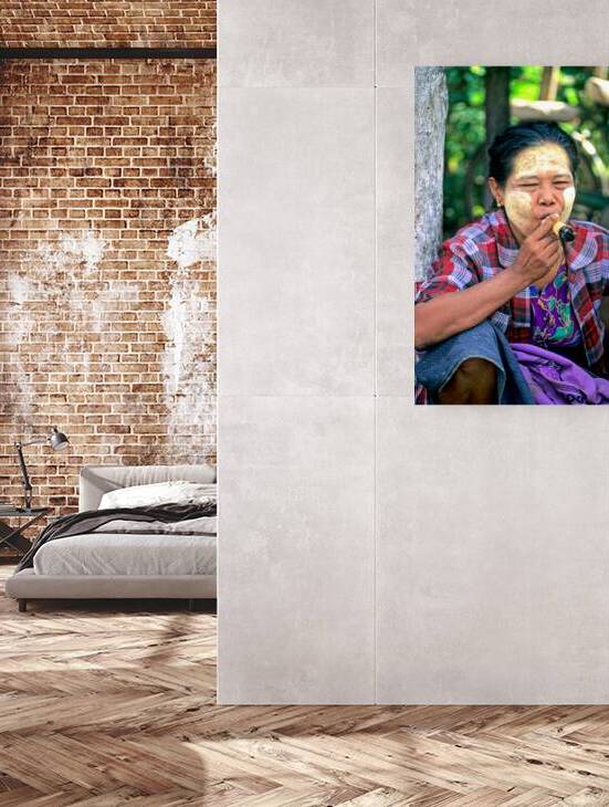 Portrait of a woman smoking in Myanmar during a sunny day by Marco Brivio