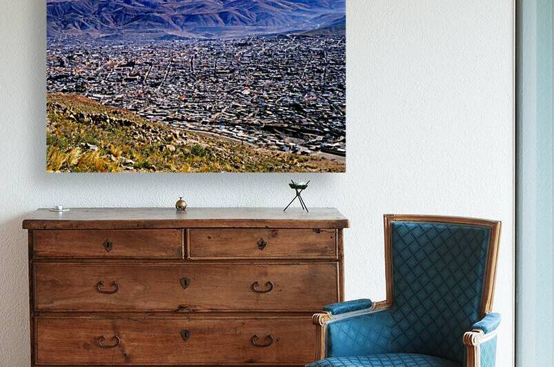 Panoramic view of a sprawling city in a mountain valley. by Marco Brivio