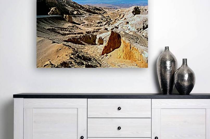 Dramatic arid mountain landscape with a winding road. by Marco Brivio