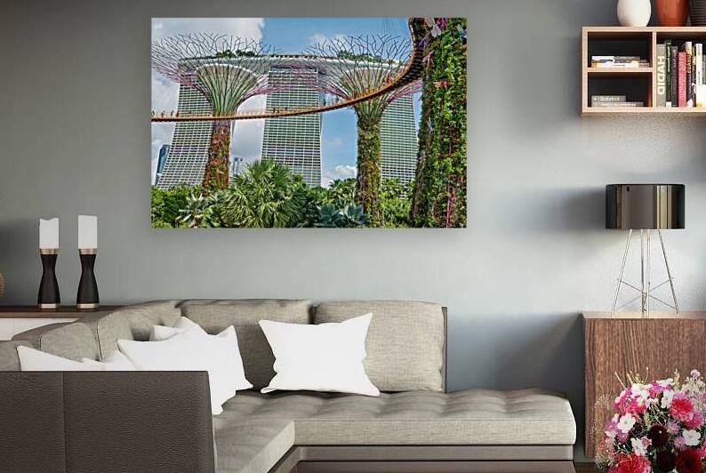 People walk on bridge connecting to Supertree Grove in Singapore by Marco Brivio