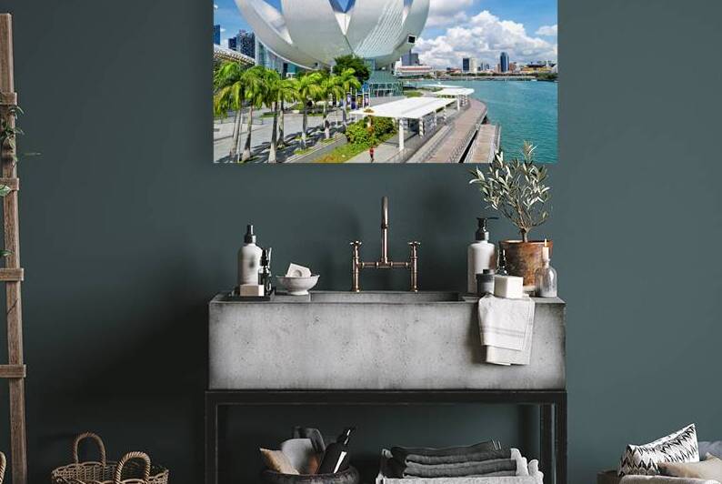 Visitors enjoy view of ArtScience Museum in Singapore near water by Marco Brivio