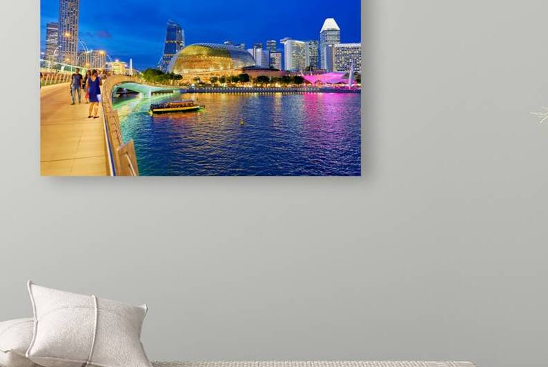 People walk by Marina Bay waterfront as city lights turn on at s by Marco Brivio