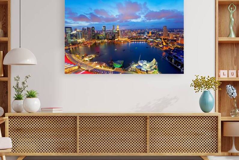 City lights shine over Marina Bay in Singapore at sunset by Marco Brivio