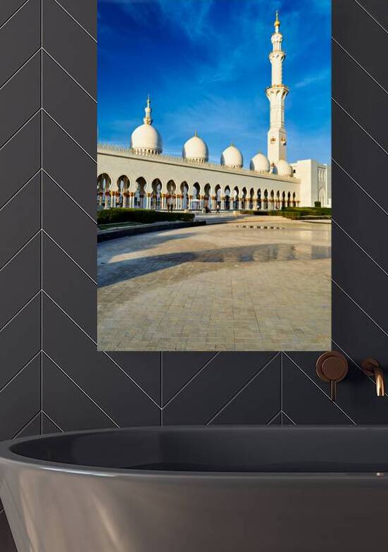 Beautiful mosque stands tall in Abu Dhabi under blue sky by Marco Brivio