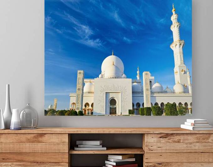 Abu Dhabi mosque stands tall under blue sky by Marco Brivio