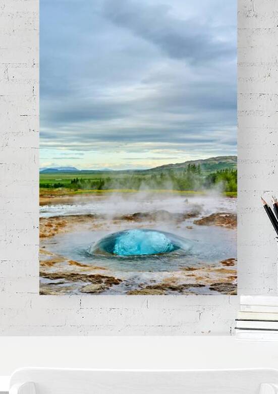 Strokkur geyser erupts in Iceland during cloudy day by Marco Brivio