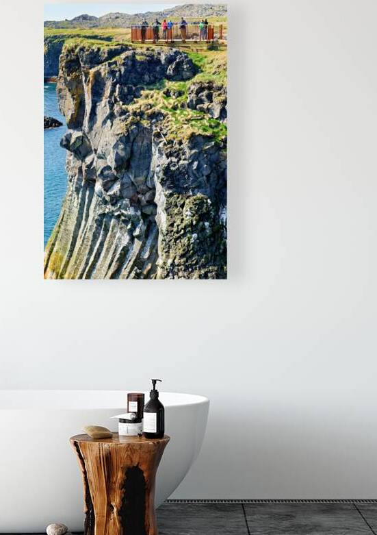 Visitors view the arnarstapi cliff in Iceland during daylight by Marco Brivio