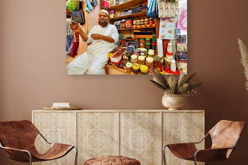 Shopkeeper sits at Mutrah Souq in Muscat Oman by Marco Brivio