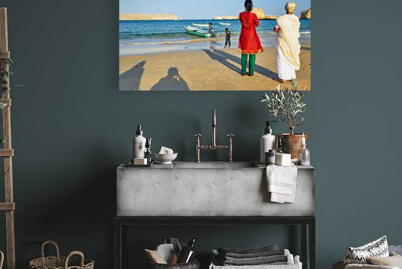 Locals watch boats at Muscat Oman beach in the daytime by Marco Brivio