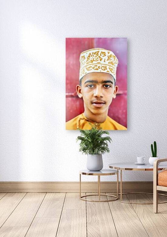 Boy in traditional dress in Muscat Oman during daytime by Marco Brivio