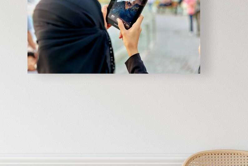Veiled woman using a tablet in Istanbul Turkey by Marco Brivio