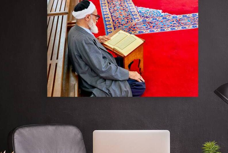Man reading Quran in Fatih Mosque in Istanbul Turkey by Marco Brivio