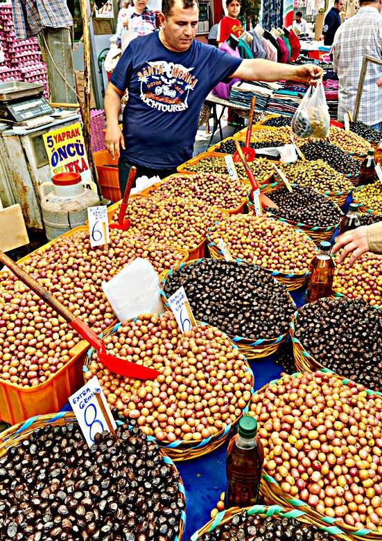 Street market in Istanbul with vendors and various goods by Marco Brivio