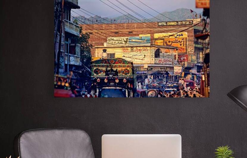 Busy market scene in Mingora Pakistan with vehicles and shops by Marco Brivio