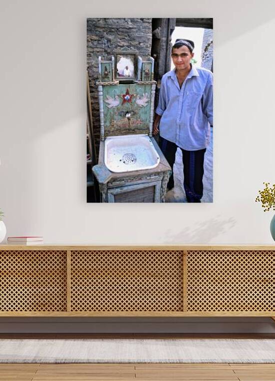 Man stands near traditional washbasin in Khiva Uzbekistan by Marco Brivio