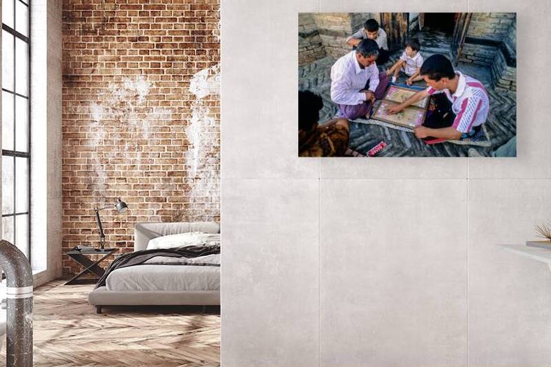 Men playing a board game in daylight in Khiva by Marco Brivio